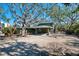 House exterior showcasing a carport and mature landscaping at 7147 Point Of Rocks Cir, Sarasota, FL 34242