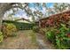 Landscaped backyard with tropical plants and mature trees at 7363 Silver Fern Blvd # 80, Sarasota, FL 34241