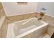 Relaxing bathroom with corner jetted tub and decorative tile at 7363 Silver Fern Blvd # 80, Sarasota, FL 34241