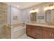 Elegant bathroom with double vanity, soaking tub, and walk-in shower at 7363 Silver Fern Blvd # 80, Sarasota, FL 34241