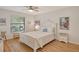 Bright bedroom with white furniture and wood-look floors at 7363 Silver Fern Blvd # 80, Sarasota, FL 34241
