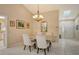 Elegant dining room with marble table and a chandelier at 7363 Silver Fern Blvd # 80, Sarasota, FL 34241