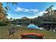 Serene lake view with two park benches at 7363 Silver Fern Blvd # 80, Sarasota, FL 34241