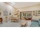 Living room features a grand piano and access to a sunroom at 7363 Silver Fern Blvd # 80, Sarasota, FL 34241