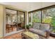 Screened patio features wicker furniture and a grill at 7363 Silver Fern Blvd # 80, Sarasota, FL 34241