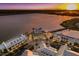 Aerial view of waterfront community at sunset, featuring shops and a town square at 7420 Newham Ln, Sarasota, FL 34240