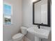 Small bathroom with pedestal sink and window at 7420 Newham Ln, Sarasota, FL 34240