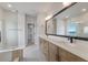 Modern bathroom with double vanity, large mirror, and walk-in shower at 7420 Newham Ln, Sarasota, FL 34240