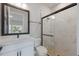 Modern bathroom with a walk-in shower and white vanity at 7420 Newham Ln, Sarasota, FL 34240