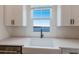 Modern kitchen sink with lake view at 7420 Newham Ln, Sarasota, FL 34240