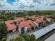 Aerial view of condo complex with red tile roofs, parking, and lush landscaping at 800 S Blvd Of Presidents # 12, Sarasota, FL 34236