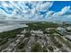 Aerial view of mangrove preserve with parking area and calm waters at 800 S Blvd Of Presidents # 12, Sarasota, FL 34236