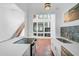 Modern kitchen with island, stainless steel appliances, and white cabinets at 800 S Blvd Of Presidents # 12, Sarasota, FL 34236
