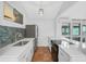 Modern kitchen featuring white cabinets and stainless steel appliances at 800 S Blvd Of Presidents # 12, Sarasota, FL 34236