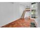 Open living area with terracotta floors and staircase to loft at 800 S Blvd Of Presidents # 12, Sarasota, FL 34236