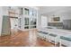Open living area with kitchen, staircase, and terracotta tile floors at 800 S Blvd Of Presidents # 12, Sarasota, FL 34236