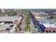 Aerial view of a city street with palm trees and shops at 829 Harbor S Dr, Venice, FL 34285