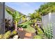 Landscaped backyard with tropical plants and a grassy area at 829 Harbor S Dr, Venice, FL 34285