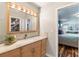 Bathroom with vanity, sink, and a view of the bedroom at 829 Harbor S Dr, Venice, FL 34285