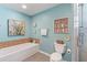 Light blue bathroom with soaking tub and decorative accents at 829 Harbor S Dr, Venice, FL 34285