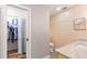 Bathroom with walk-in closet, light wood cabinets, and a toilet at 829 Harbor S Dr, Venice, FL 34285