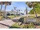 Private beach access path with tropical landscaping, leading to the ocean at 829 Harbor S Dr, Venice, FL 34285