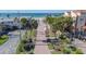 Brick pathway leading to beach with palm trees and ocean view at 829 Harbor S Dr, Venice, FL 34285