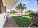 Relaxing front porch with seating and palm trees at 829 Harbor S Dr, Venice, FL 34285