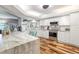 Spacious kitchen with white cabinets, granite island, and hardwood floors at 829 Harbor S Dr, Venice, FL 34285