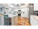 Bright kitchen featuring white cabinets and hardwood floors at 829 Harbor S Dr, Venice, FL 34285