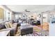 Bright living room with hardwood floors, leather sectional sofa, and view of kitchen at 829 Harbor S Dr, Venice, FL 34285