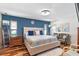 Spacious main bedroom with a large bed and blue accent wall at 829 Harbor S Dr, Venice, FL 34285