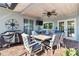 Brick patio with outdoor dining set, grill, and ceiling fan at 829 Harbor S Dr, Venice, FL 34285