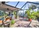 Relaxing screened patio with brick pavers and lush landscaping at 829 Harbor S Dr, Venice, FL 34285