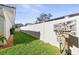 Long side yard with grassy area and wooden sign at 829 Harbor S Dr, Venice, FL 34285