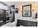 Modern bathroom featuring black tiled shower, updated sink, and vanity with marble countertops and modern lighting at 8388 Catamaran Cir, Lakewood Ranch, FL 34202