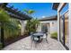 Outdoor living space with paved patio, pergola, seating area, and lush landscaping at 8388 Catamaran Cir, Lakewood Ranch, FL 34202