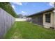 Large backyard with grassy area and wooden fence at 8469 Cypress Lake Cir, Sarasota, FL 34243