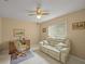 Cozy bedroom with a comfortable sofa and built-in desk at 8469 Cypress Lake Cir, Sarasota, FL 34243
