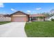 Single-story house with attached garage, and well-maintained lawn at 8469 Cypress Lake Cir, Sarasota, FL 34243