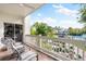 Private balcony with water views, comfortable seating, and white railings at 866 Hudson Ave # 866, Sarasota, FL 34236