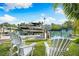 Relaxing view of private boat dock with lift and two white Adirondack chairs at 866 Hudson Ave # 866, Sarasota, FL 34236