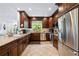 Gourmet kitchen featuring granite countertops and dark wood cabinets at 866 Hudson Ave # 866, Sarasota, FL 34236