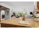 Spacious kitchen with granite countertops, dark wood cabinets, and views into living area at 866 Hudson Ave # 866, Sarasota, FL 34236