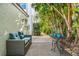 Relaxing patio with wicker sofa and metal table and chairs, nestled amongst tropical foliage at 866 Hudson Ave # 866, Sarasota, FL 34236
