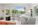 Modern wet bar with glass top and sleek white cabinetry, adjacent to balcony at 866 Hudson Ave # 866, Sarasota, FL 34236