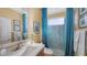 Bathroom with a shower, blue tile, and a vanity with a sink at 872 Clear Lake Dr, Englewood, FL 34223
