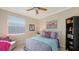 Bright bedroom with a queen bed, ceiling fan, and window coverings at 872 Clear Lake Dr, Englewood, FL 34223