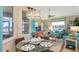 Casual breakfast nook with glass-top table and seating for four, adjacent to the kitchen at 872 Clear Lake Dr, Englewood, FL 34223