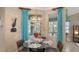Bright breakfast nook with glass table, and views of the backyard and water at 872 Clear Lake Dr, Englewood, FL 34223